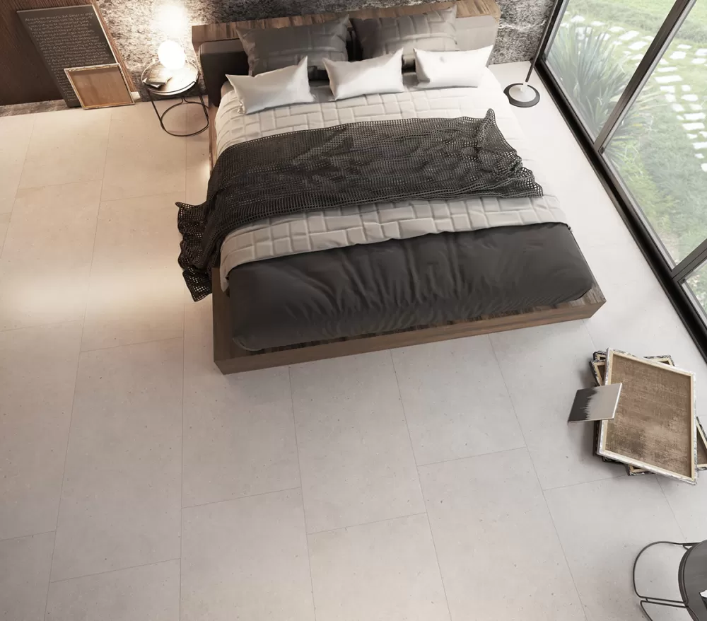 Bloom bedroom floor with a bed on top and a large window on the right